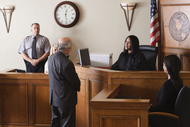 photo - Judge Listening to Lawyer in Courtroom