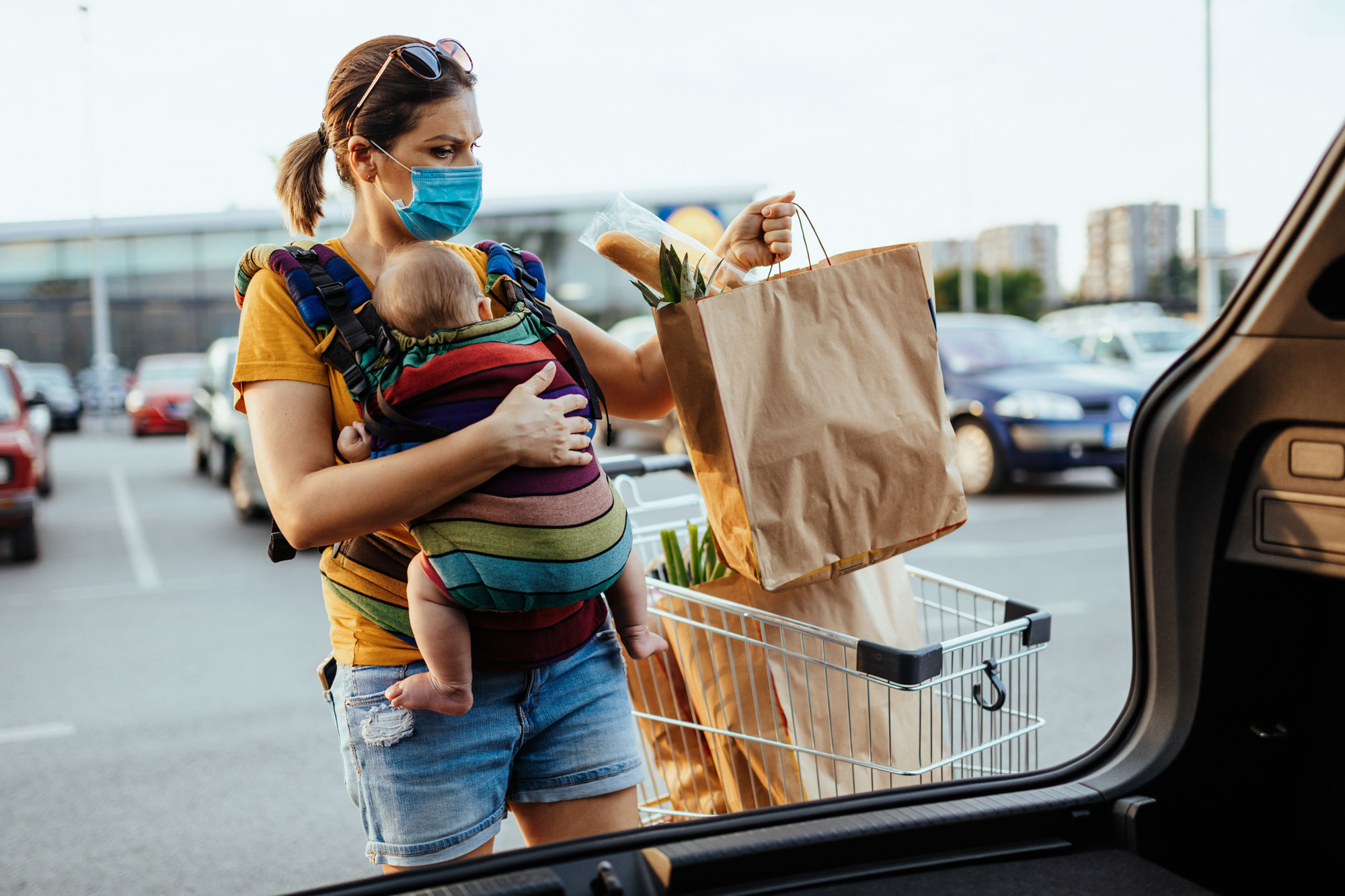 photo - Mother with Baby Putting Groceries in Car