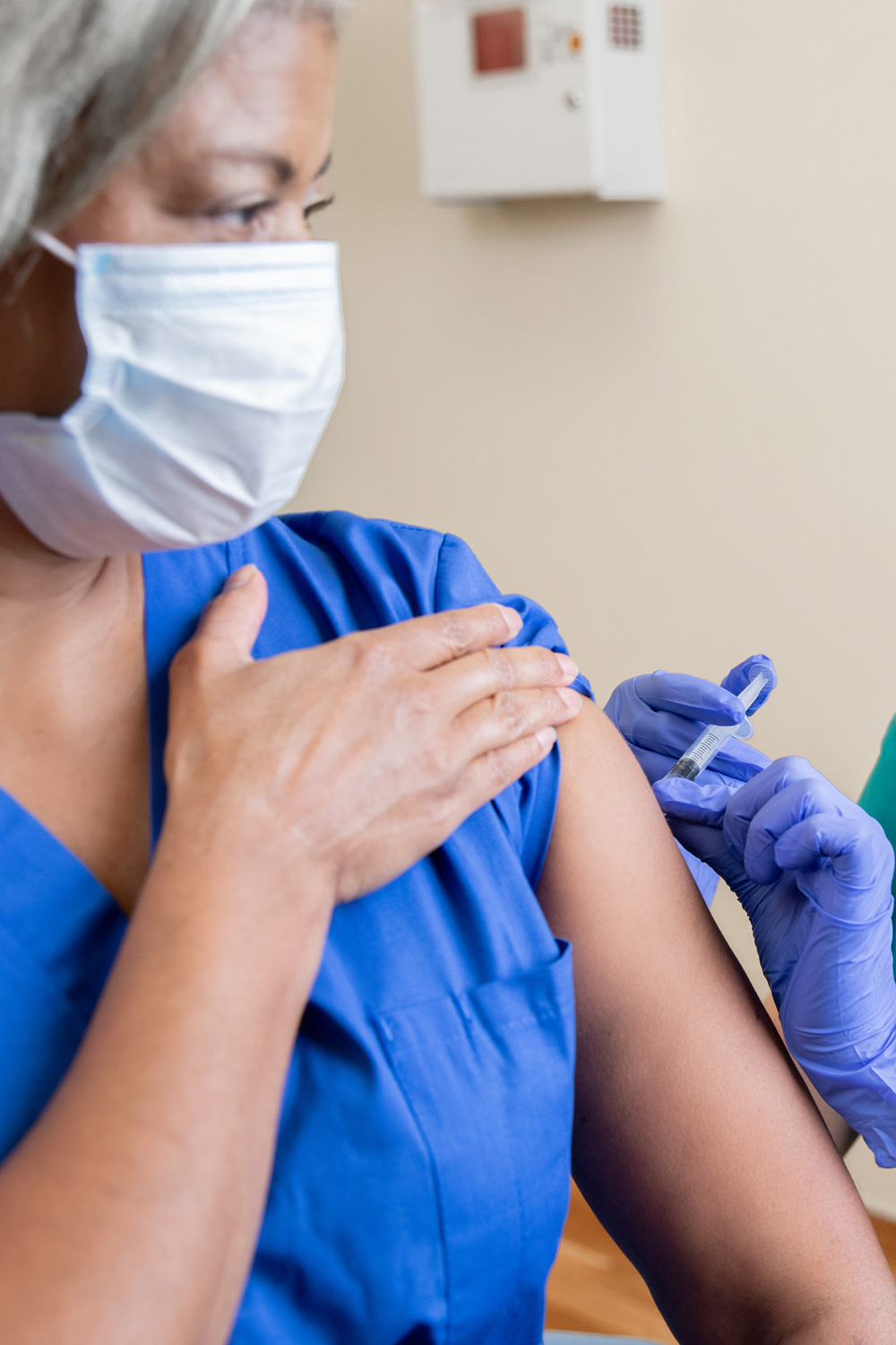 photo - Nurse Vaccinates Senior Healthcare Worker