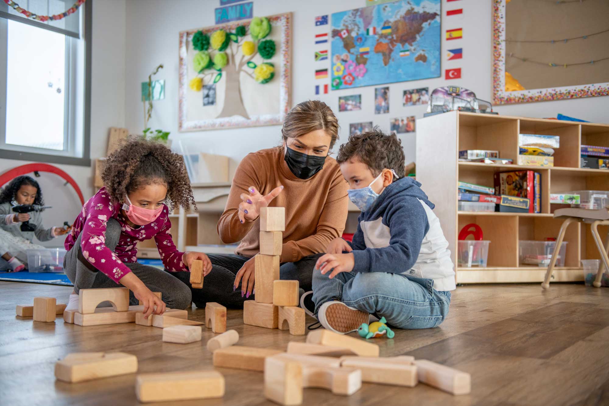 photo - Preschool Children and Teachers Playing with Blocks