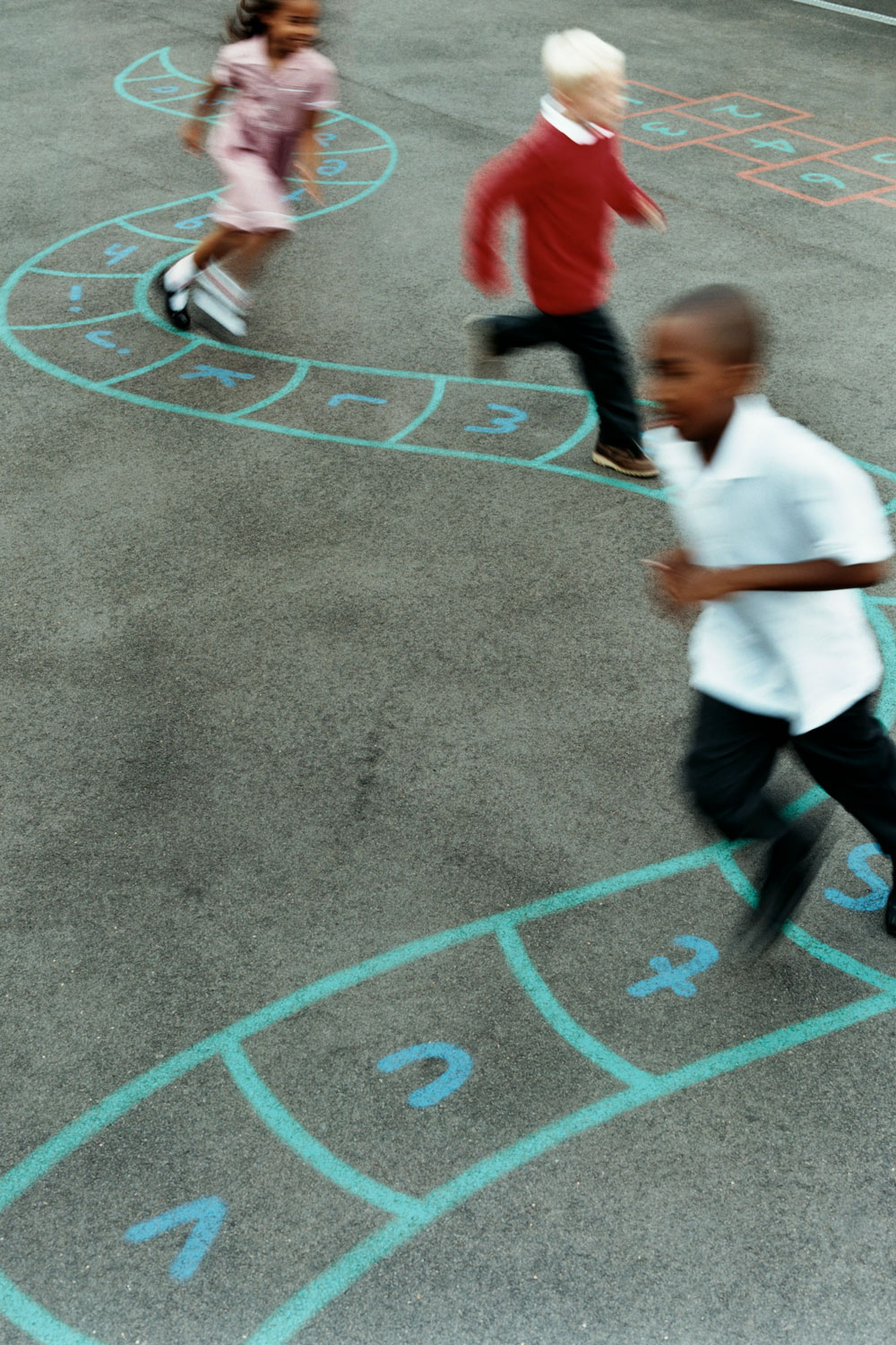 photo - Primary School Children Chasing Each Other in a School Playground