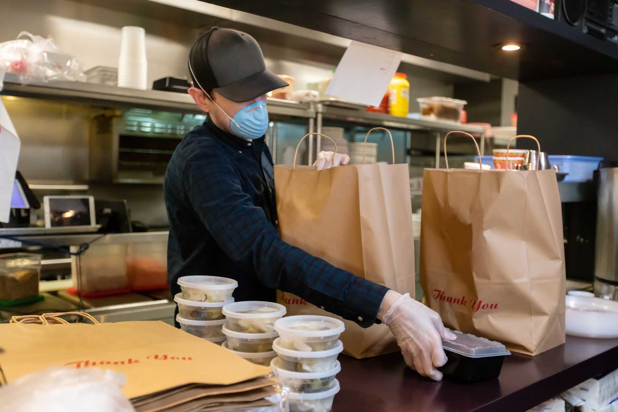 photo - Restaurant Worker Packing To Go Orders
