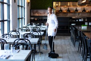 photo - Restaurant Worker Sweeping Floor
