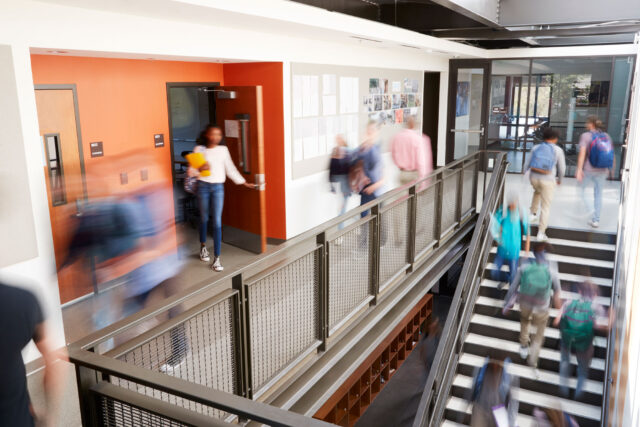 photo - school hallway with blurred students and staff