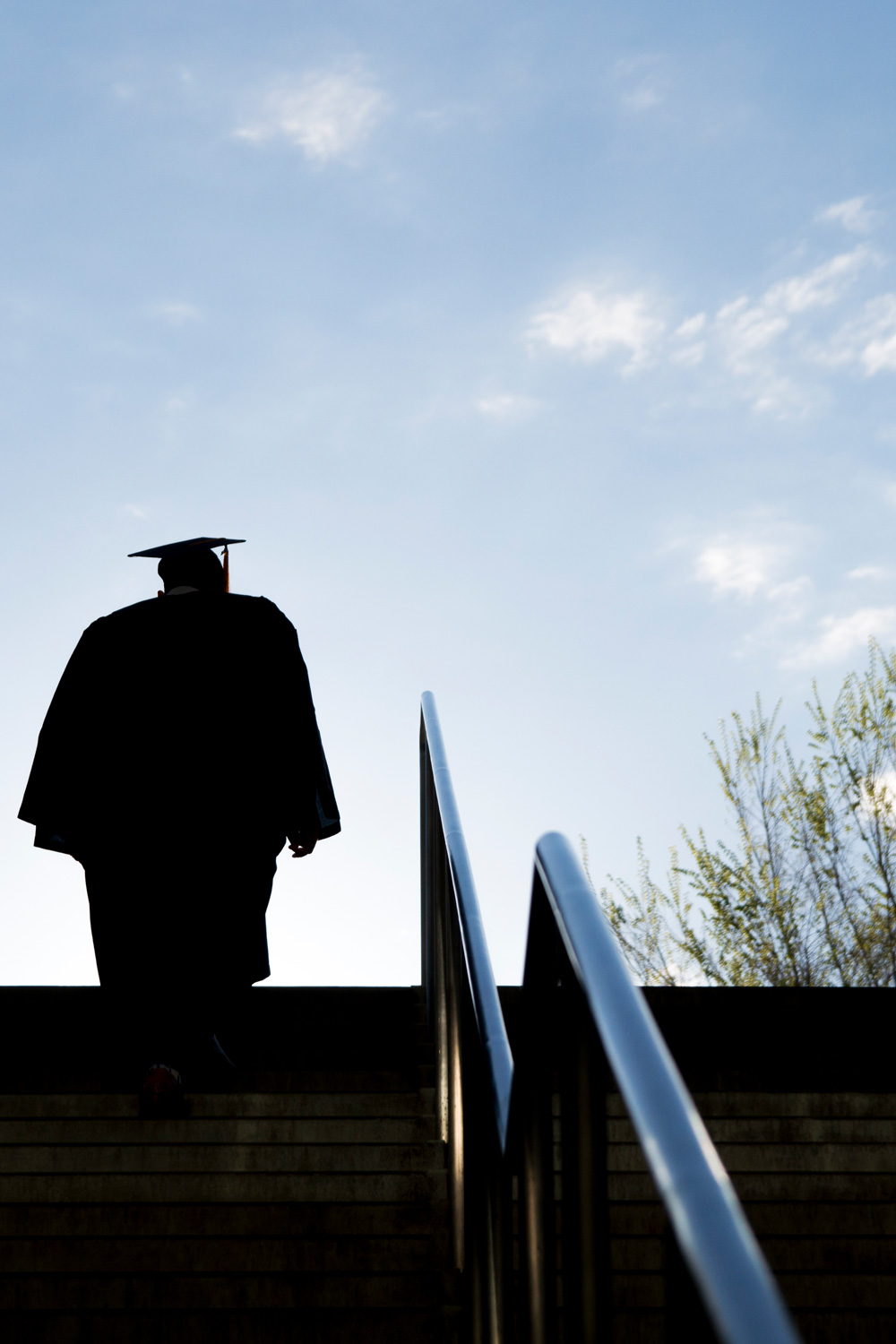 photo - Silhouette of College Graduate Climbing Steps