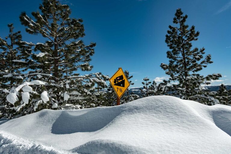photo - Snow Drifts High as Road Signage Off Highway 50