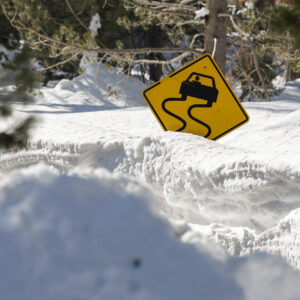 photo - Snow with Buried Windy Road Sign