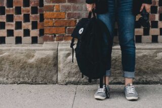 photo - Student Holding Backpack