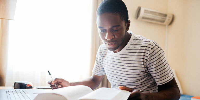 photo - Student studying in dorm room