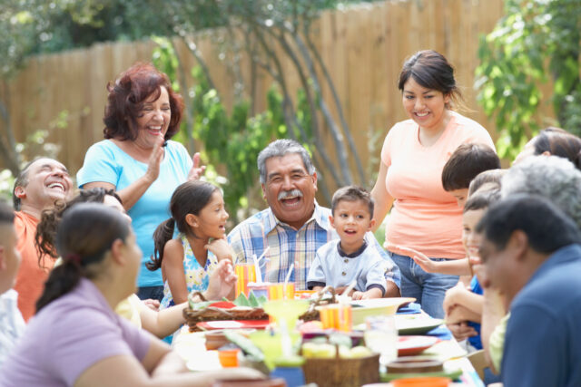 photo - Three Generation Hispanic Family Sitting at Picnic Table