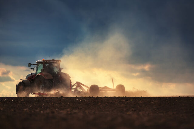 photo - Farmer in Tractor Preparing Land with Seedbed Cultivator