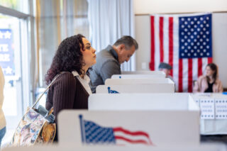 photo - Voter Looking Up from Ballot at Polling Station