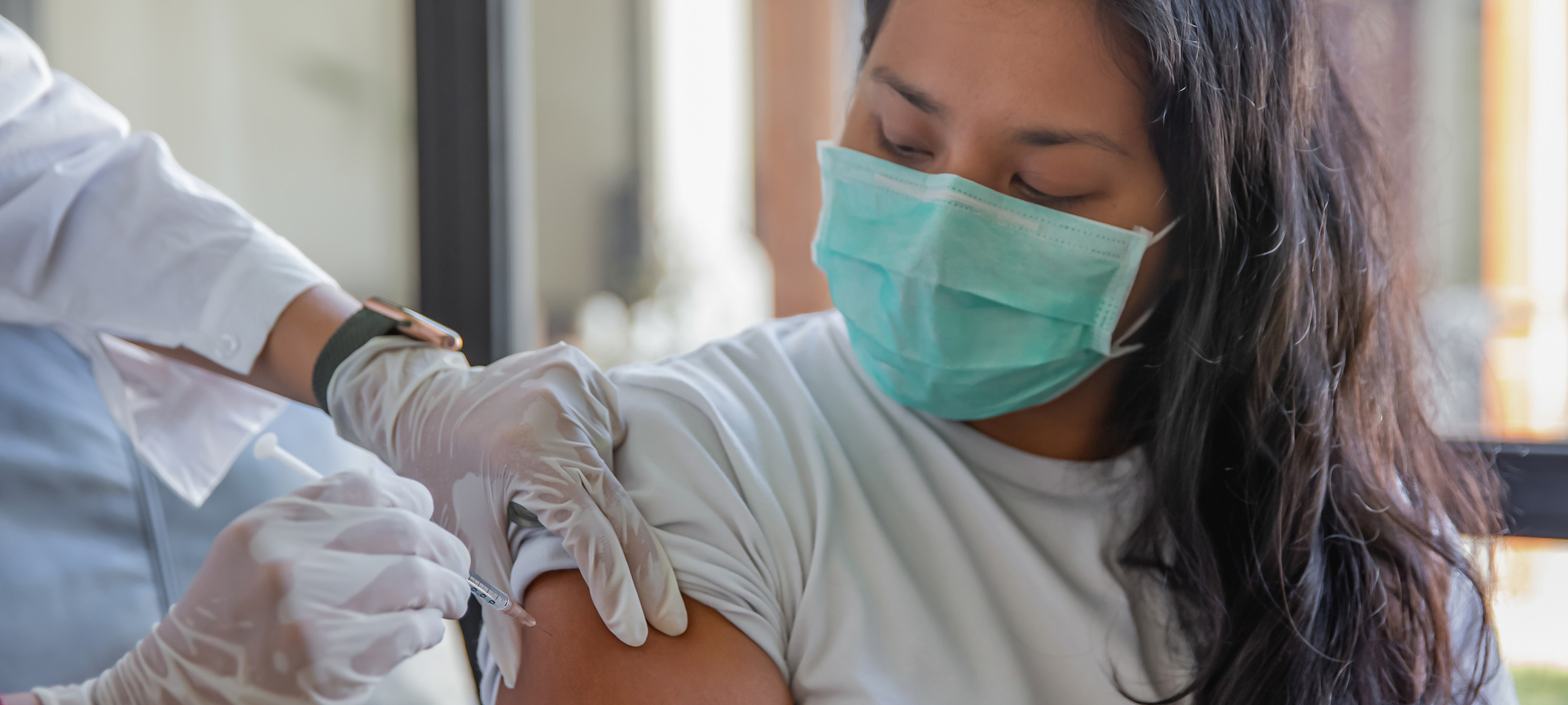 photo - Woman Receiving Covid-19 Vaccine a Home