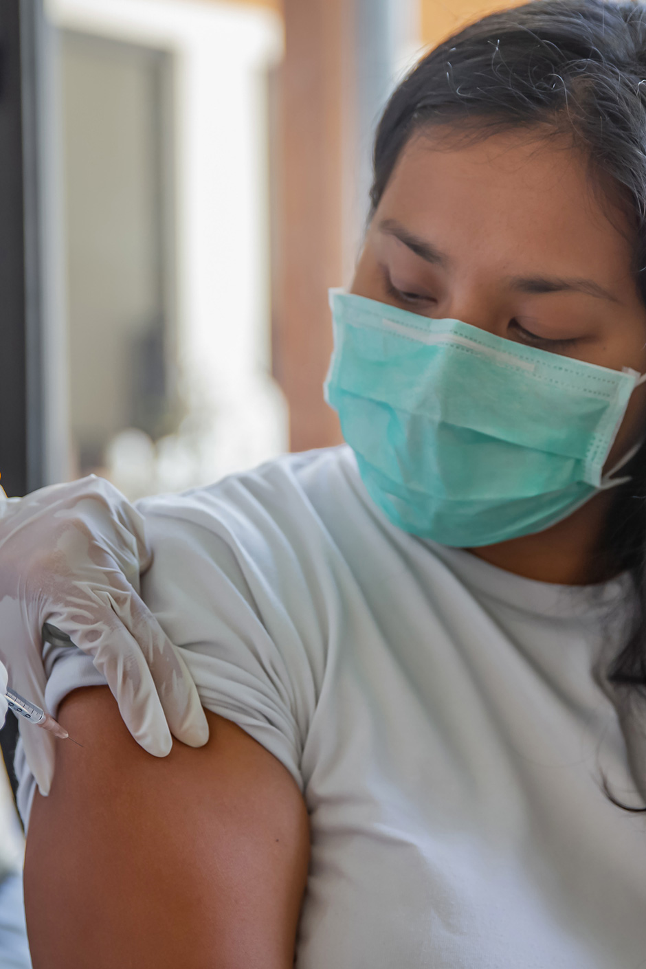 photo - Woman Receiving Covid-19 Vaccine a Home