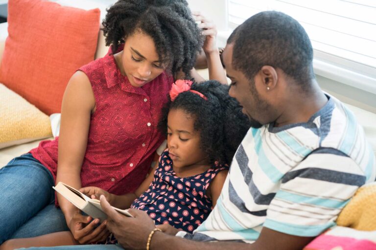 photo - Young Daughter Reading to Parents