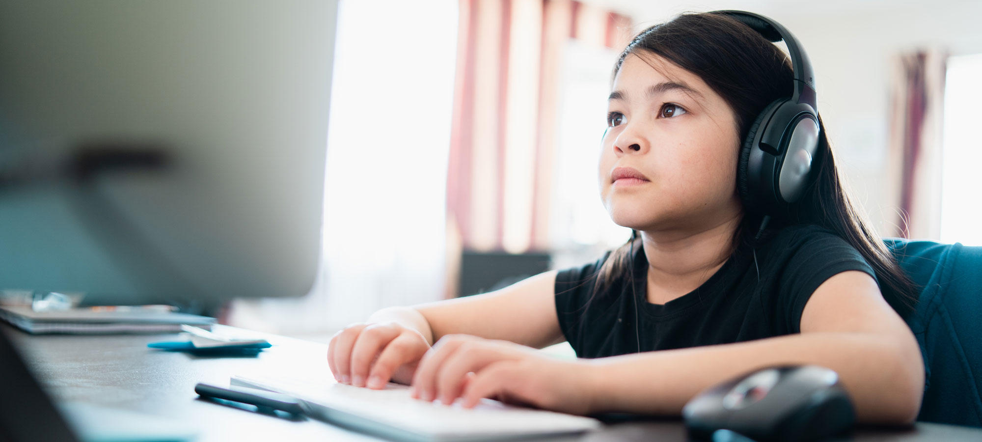 photo - Young Girl at Home on Computer Doing Homework