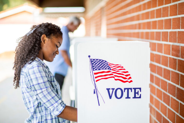 photo - Young Woman at Voting Booth